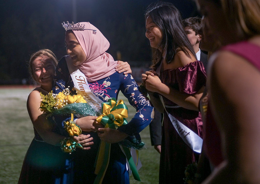 Sadia Moumita is hugged by other members of homecoming court